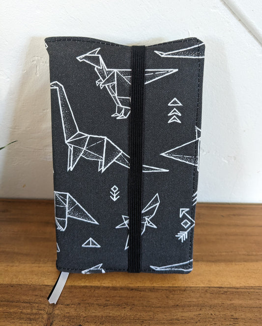 protege livre noir avec dinosaures artisanal
